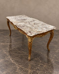 Gilt-Decorated Marble-Top Coffee Table in a styled setting