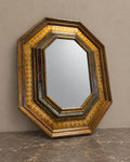 Octagonal Mirror with Chased Metal Frame in a styled setting