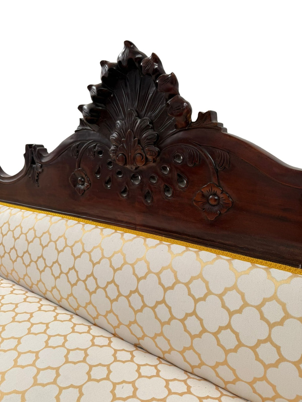Carved Mahogany Sofa with Geometric Upholstery — original carved crest and upholstery detail on white