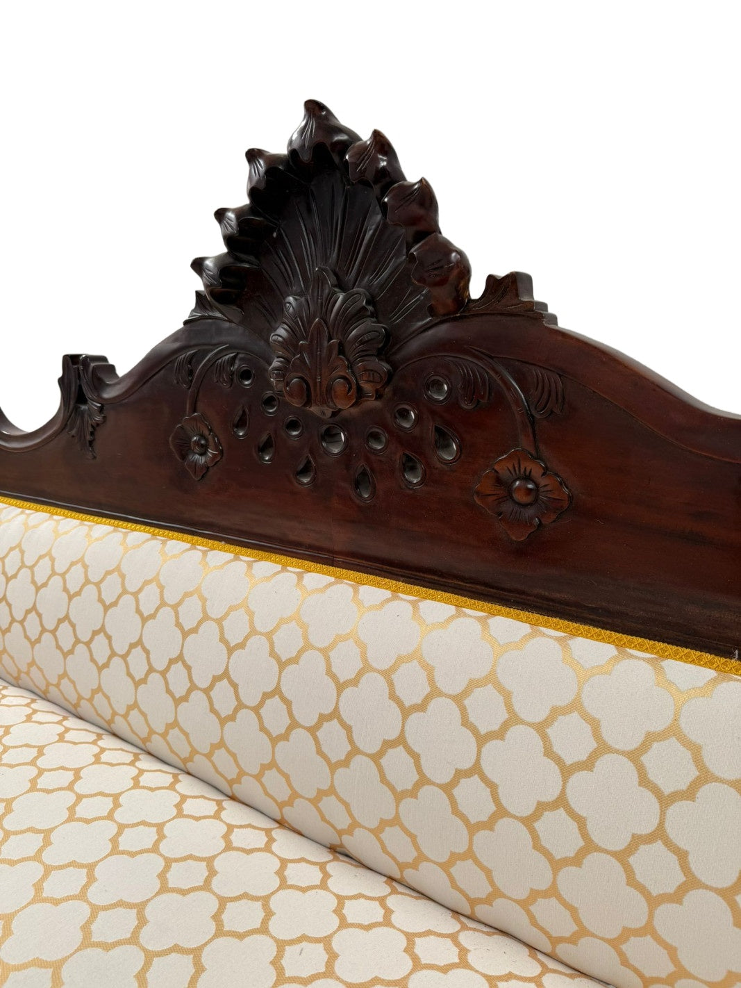 Carved Mahogany Sofa with Geometric Upholstery — original carved crest and upholstery detail on white