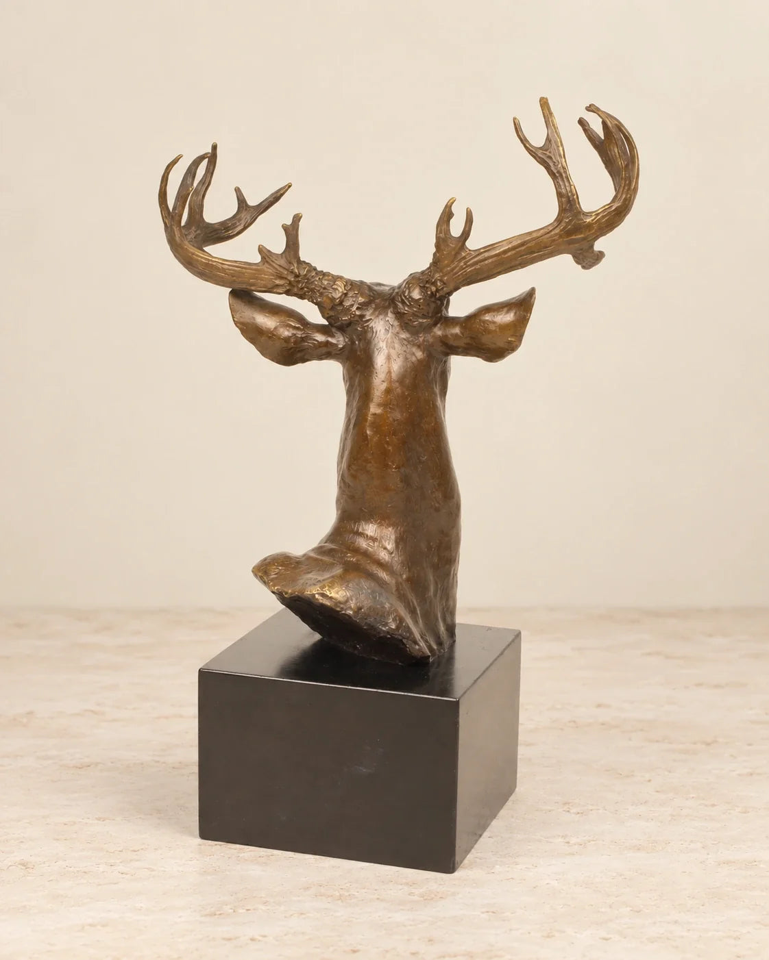 Deer Head Bronze Sculpture — second view against a warm ivory background