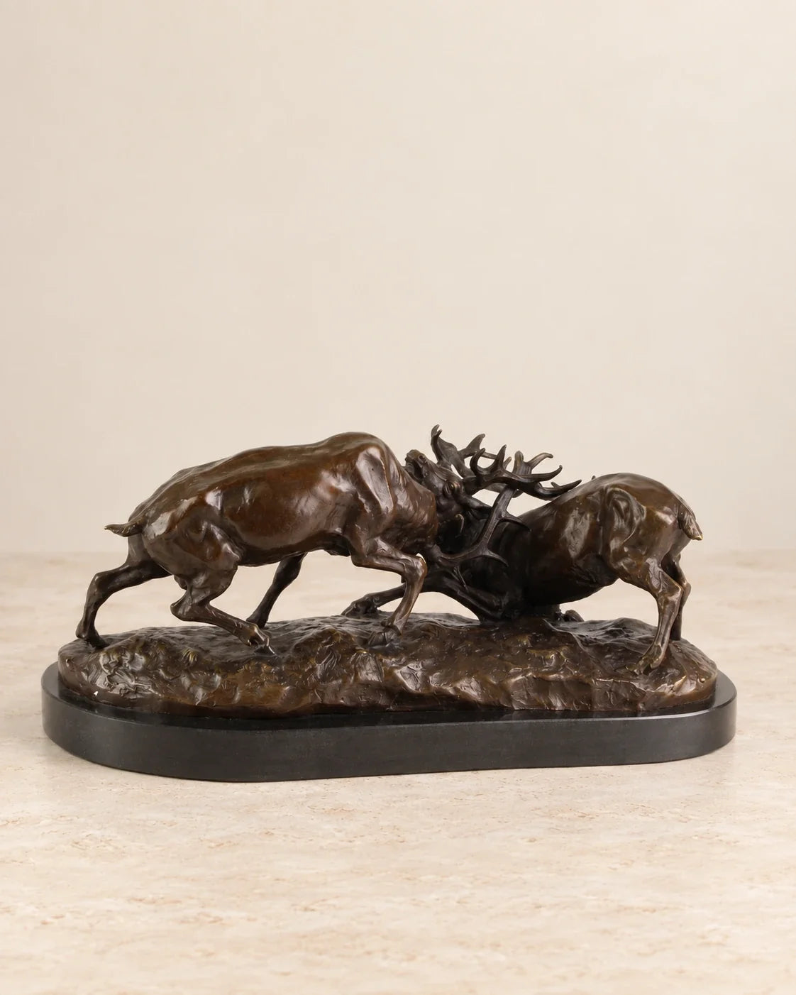 Fighting Stags Bronze Sculpture — second view against a warm ivory background