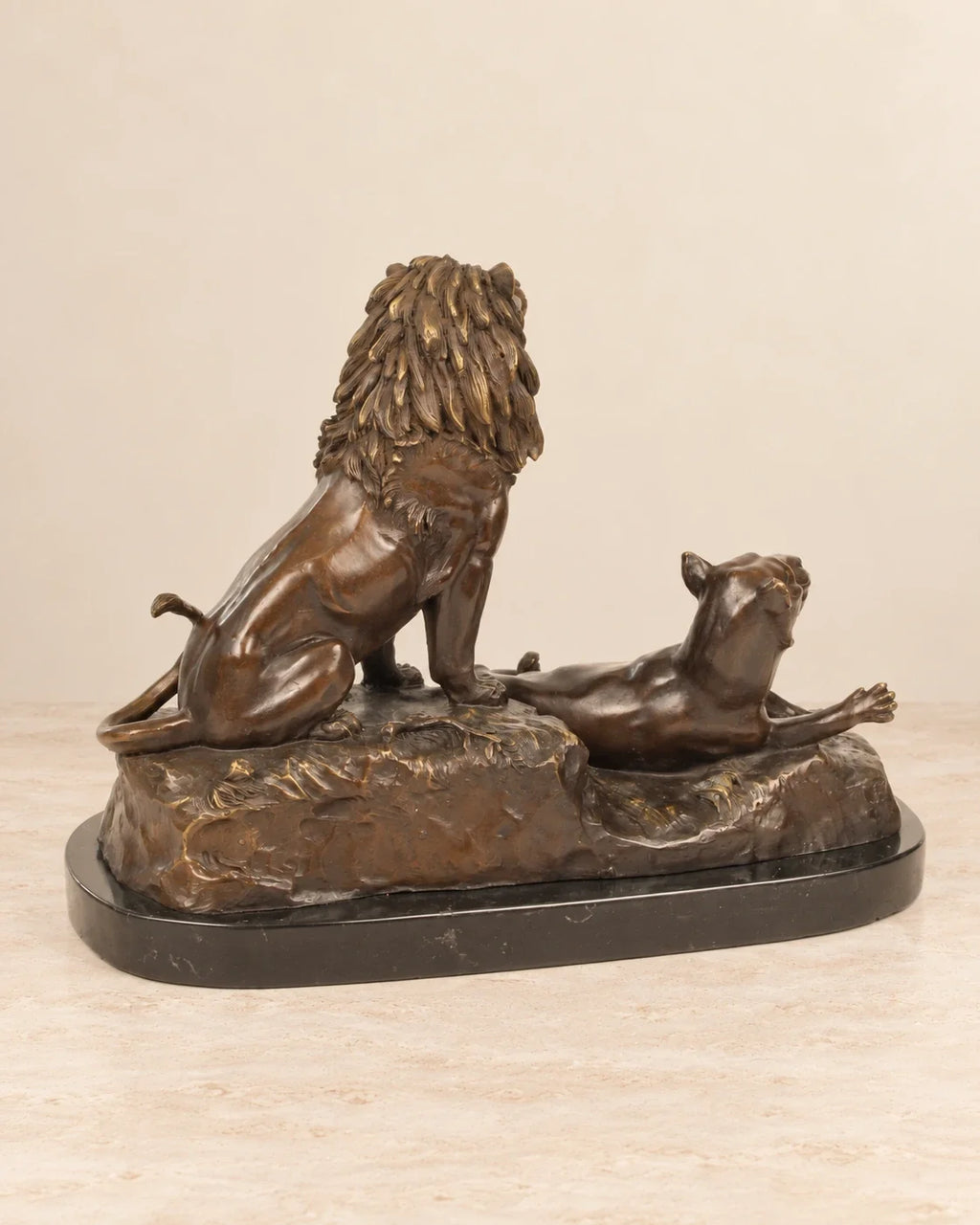 Lion and Lioness Bronze Sculpture — second view against a warm ivory background