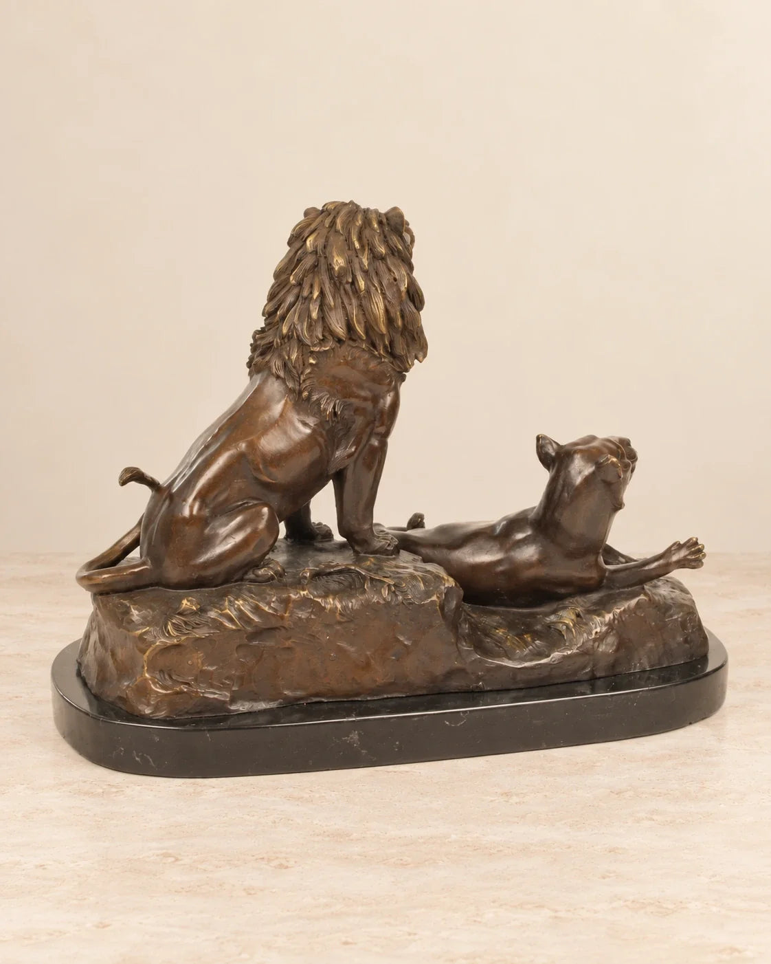 Lion and Lioness Bronze Sculpture — second view against a warm ivory background
