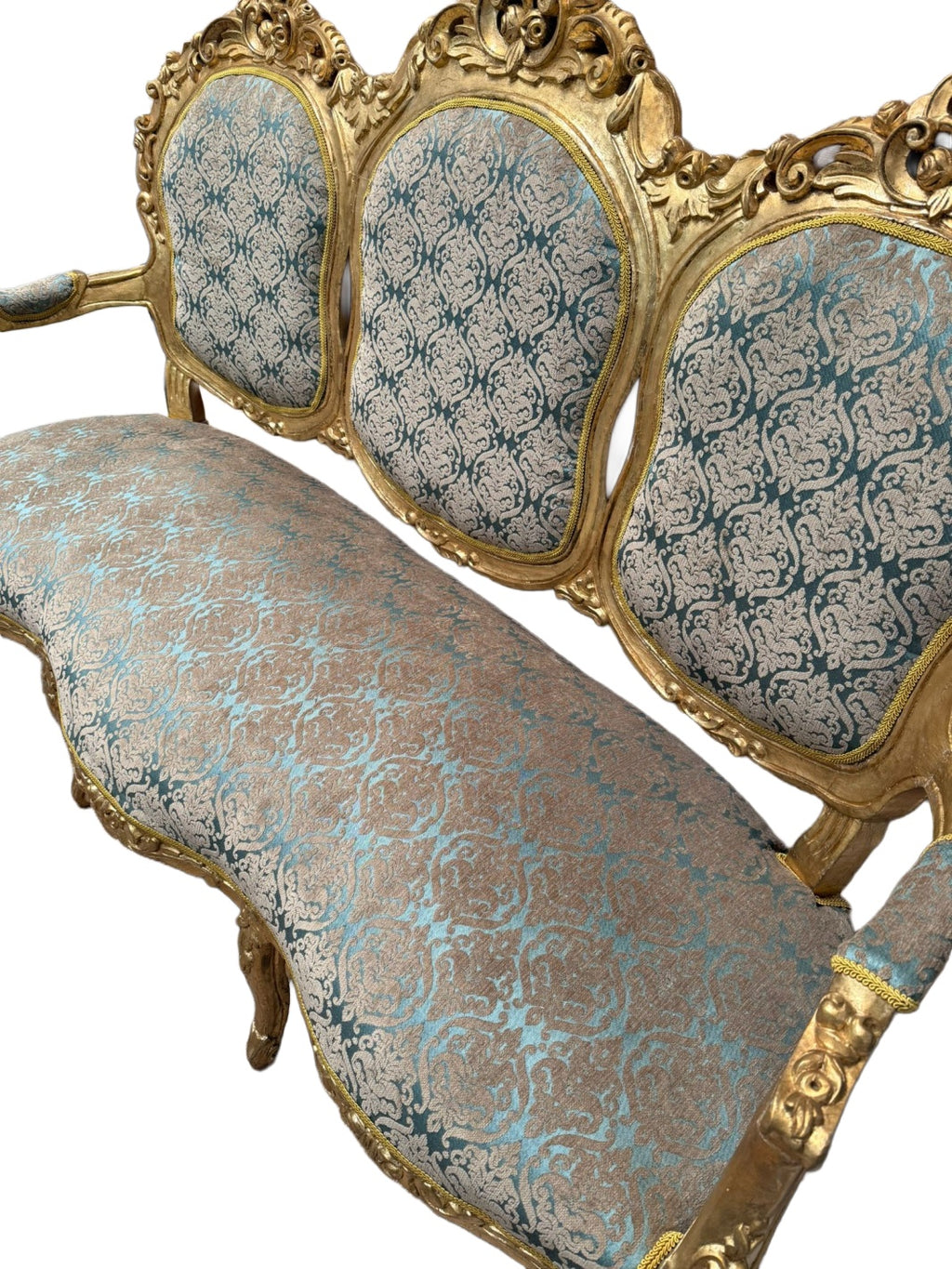 Original upholstery and carved-frame detail showing the damask pattern and finish