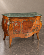 French marquetry chest with green marble top and bronze mounts in a styled setting