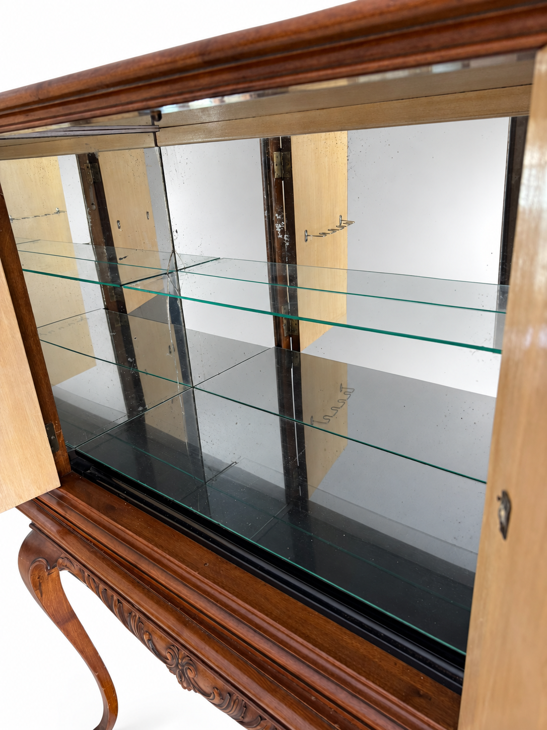 Interior of the walnut drinks cabinet with glass shelf; room reflections neutralized