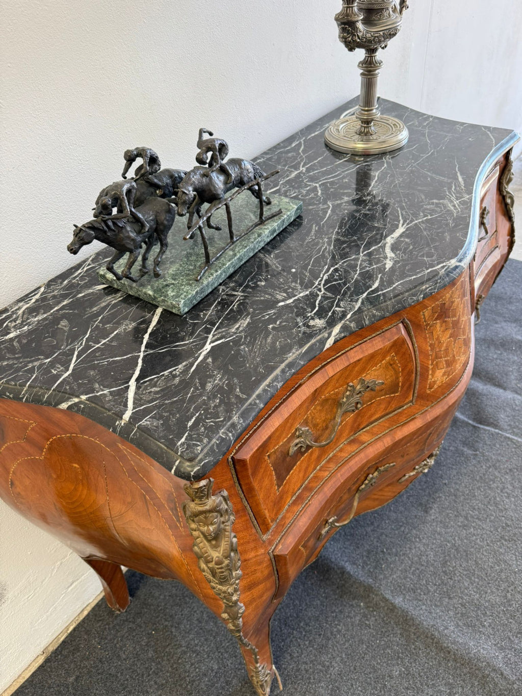 Original detail of the veined black marble top; decorative accessories not included