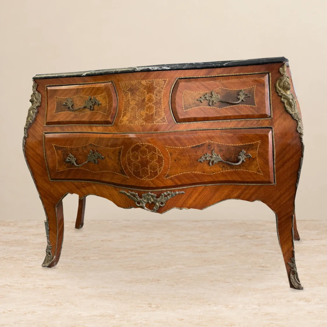 Marquetry chest of drawers with black marble top — front view