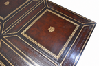 Carved Mahogany Coffee Table with Gilt-Tooled Leather Top — detail on white background