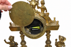 Gilt-Bronze Figural Clock and Candelabra Garniture — detail on white background