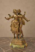 Gilt-bronze couple in period dress on a green veined marble base — main frontal view