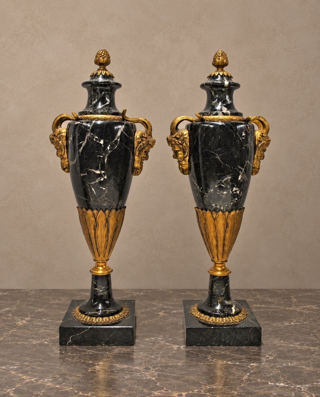 Pair of Black Marble Urns with Gilt-Bronze Masks — main view