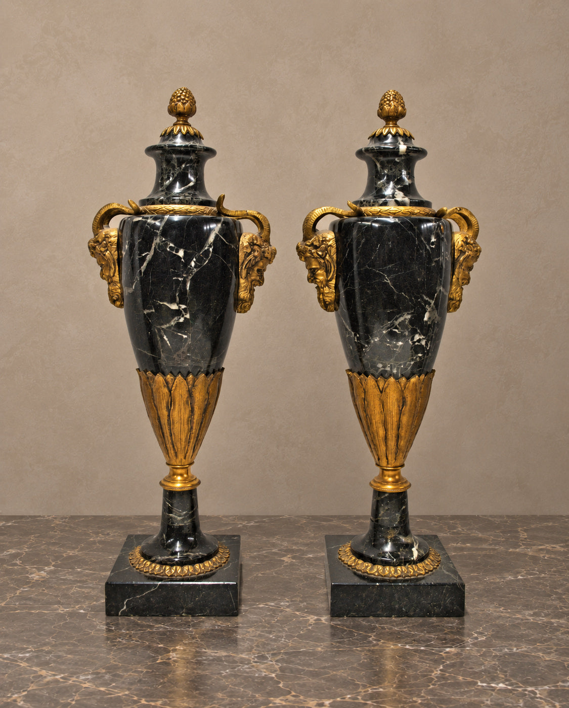 Pair of Black Marble Urns with Gilt-Bronze Masks — main view