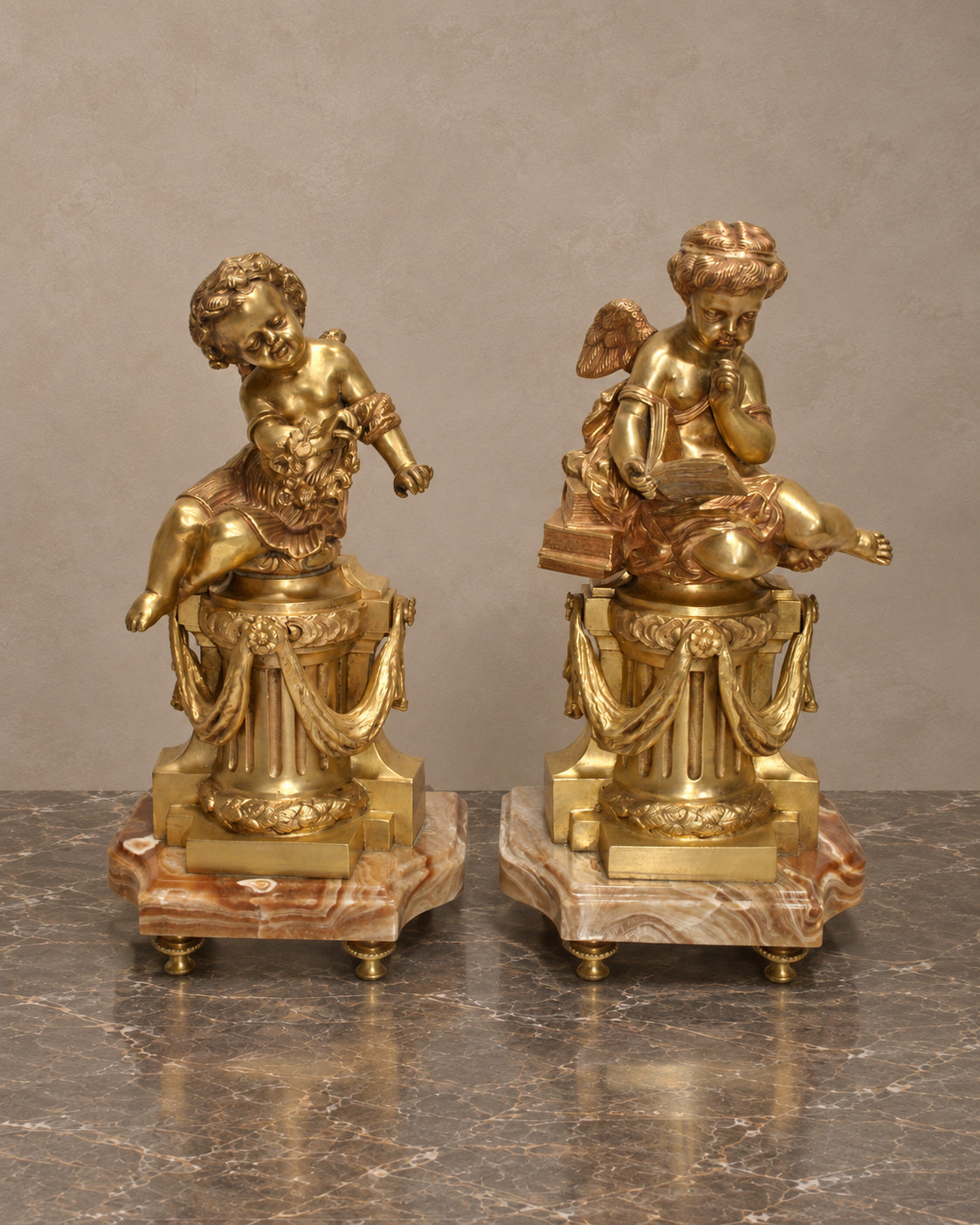 Pair of Gilt-Bronze Cherubs on Onyx Pedestals — main view