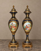 Pair of Cobalt Porcelain Lidded Vases with Romantic Scenes — main view