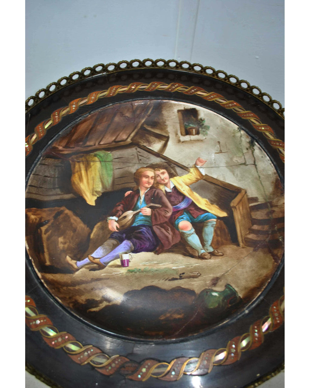 Original detail of the painted porcelain top, preserving the scene and visible restoration lines