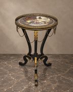 Napoleon III-style round ebonised table with painted porcelain top, gilt mounts and chain swags — main view