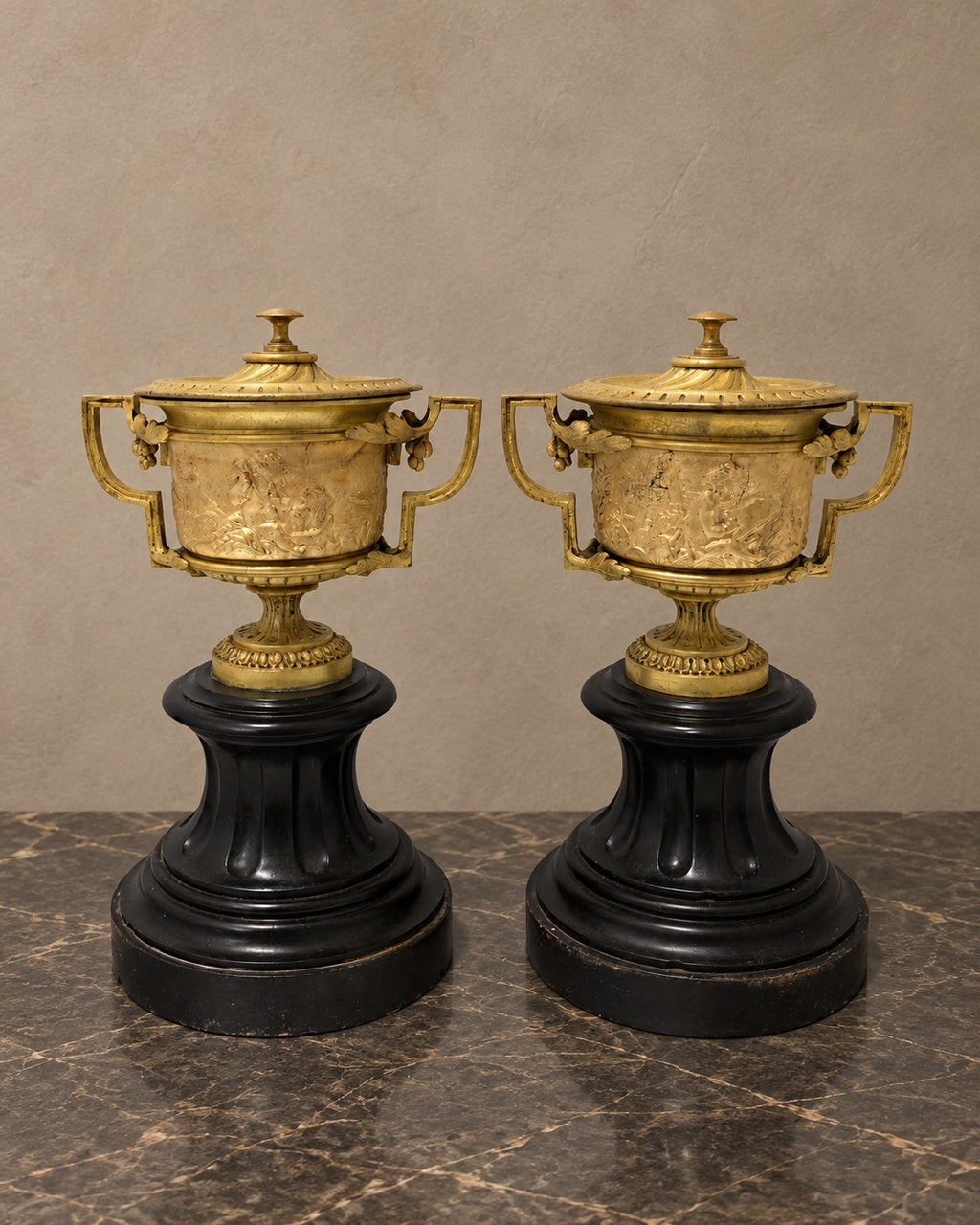 Pair of Empire-Style Bronze Covered Urns on Marble — styled main view