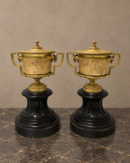 Pair of Empire-Style Bronze Covered Urns on Marble — styled main view
