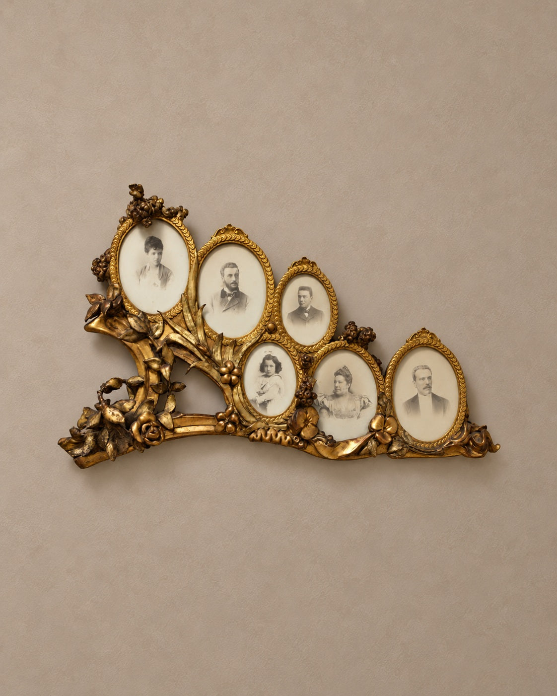 Giltwood six-portrait frame on a warm taupe wall