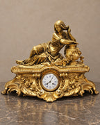 Gilt-bronze figural mantel clock signed A. Carrier, complete front view in taupe and marble setting