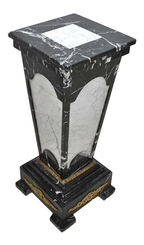 Original oblique view of the complete marble pedestal on white, showing its square top, contrasting stone panels, mounts and stepped base