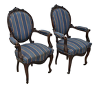Original oblique view of both Isabelino walnut armchairs on white