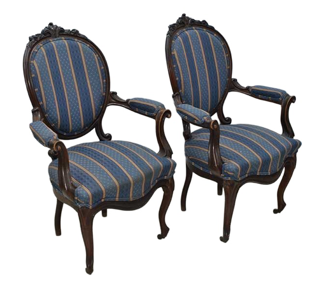 Original oblique view of both Isabelino walnut armchairs on white