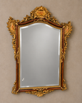 Floral-crest bevelled wall mirror with a neutral silver-grey glass surface, aged ornament and original glass marks