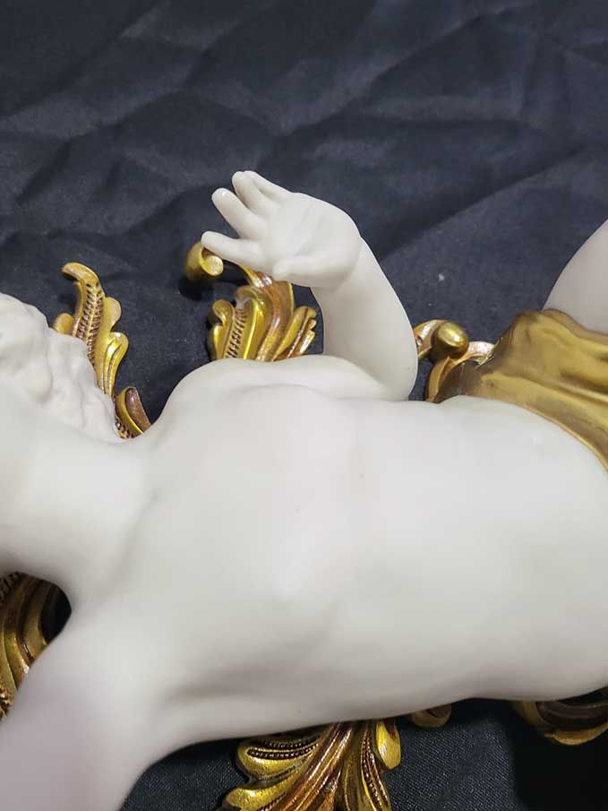 Pair of Biscuit Porcelain Musical Cherubs on Gilt-Bronze Supports — original photograph of hand and surface condition