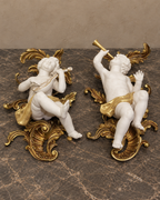 Pair of Biscuit Porcelain Musical Cherubs on Gilt-Bronze Supports — styled front view