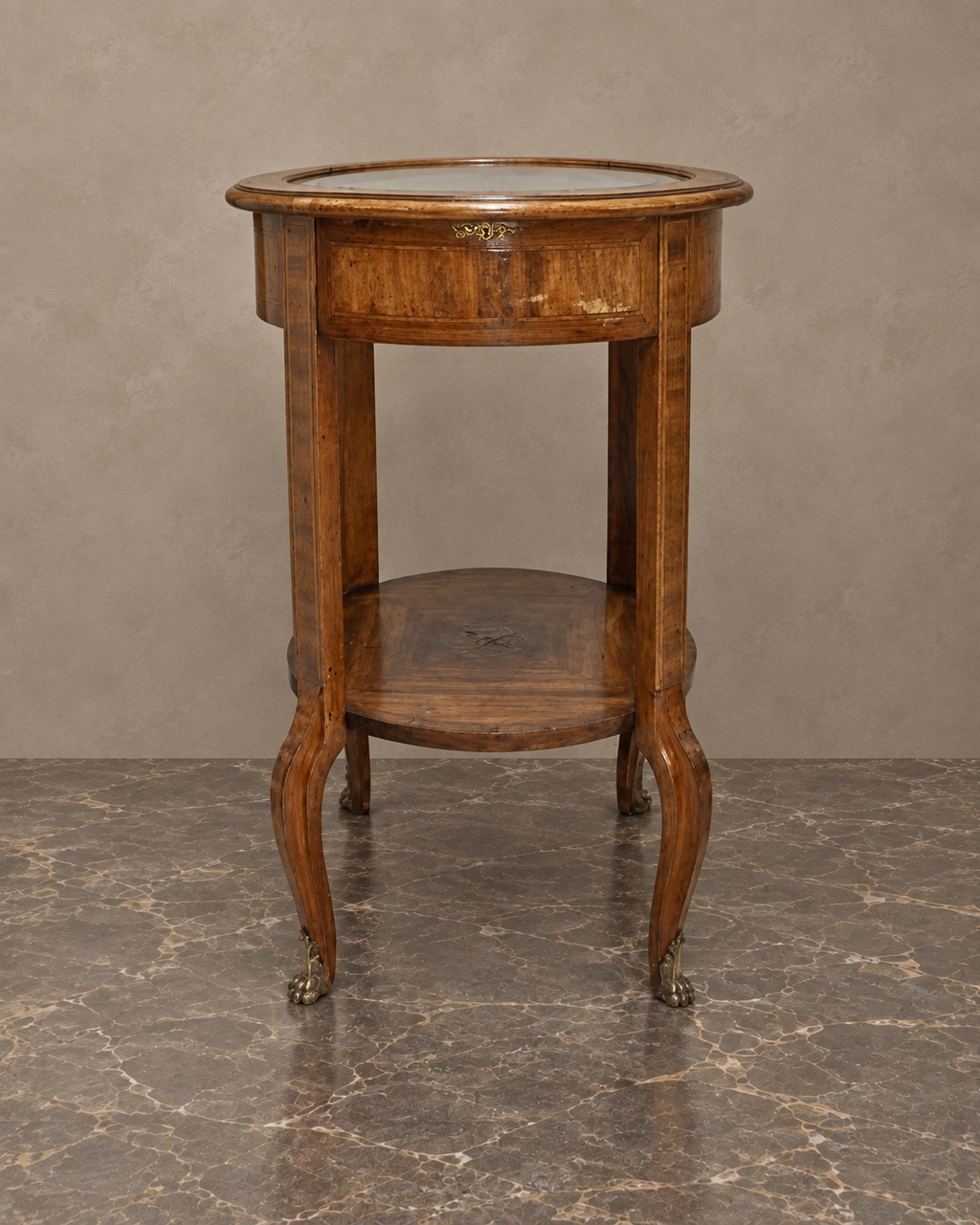 Round Glass-Top Display Table with Gilt-Bronze Claw Feet — styled front view