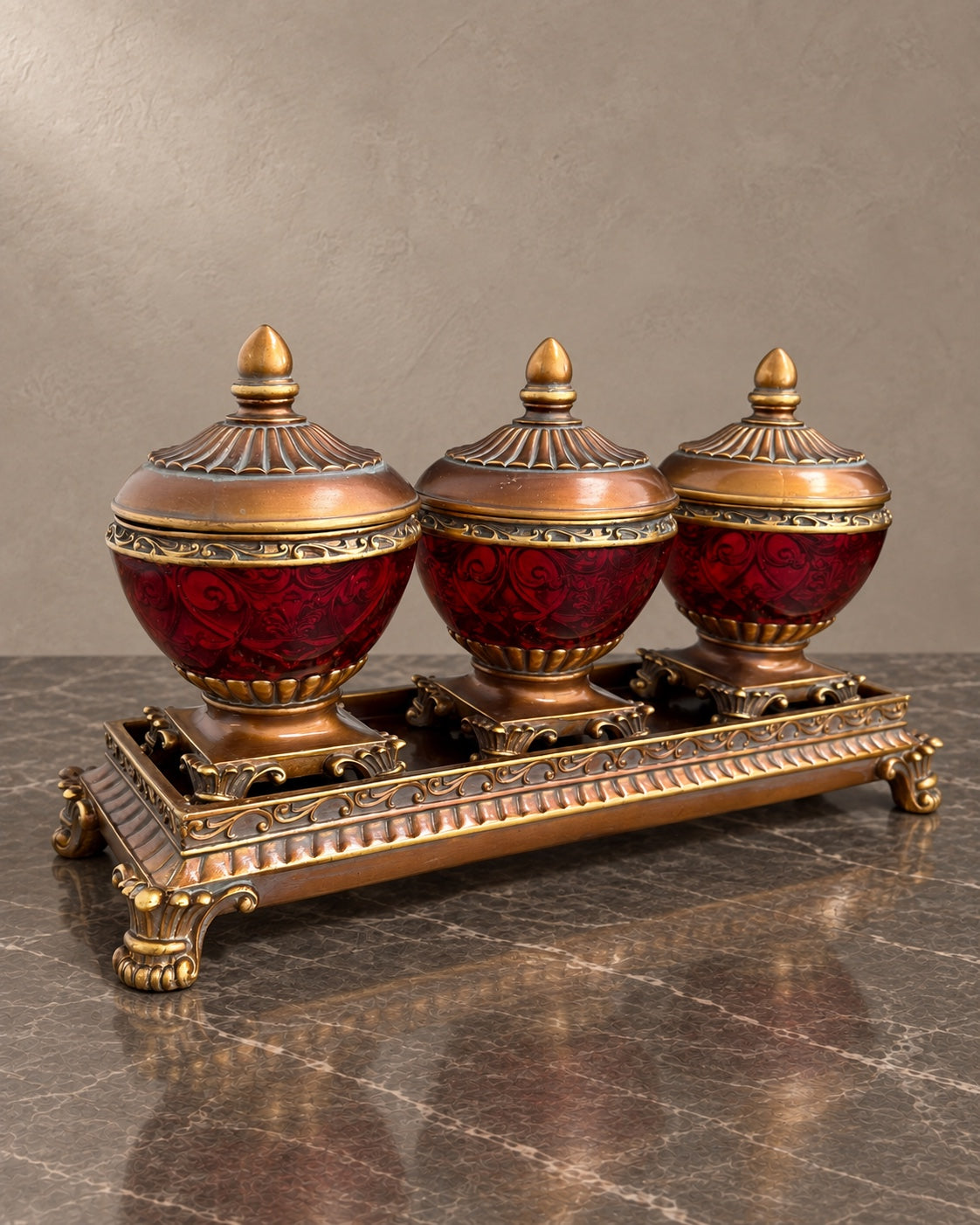 Three Ruby-Tone Covered Jars on an Ornate Stand — styled main photograph
