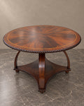 Round flame mahogany table in a warm taupe setting