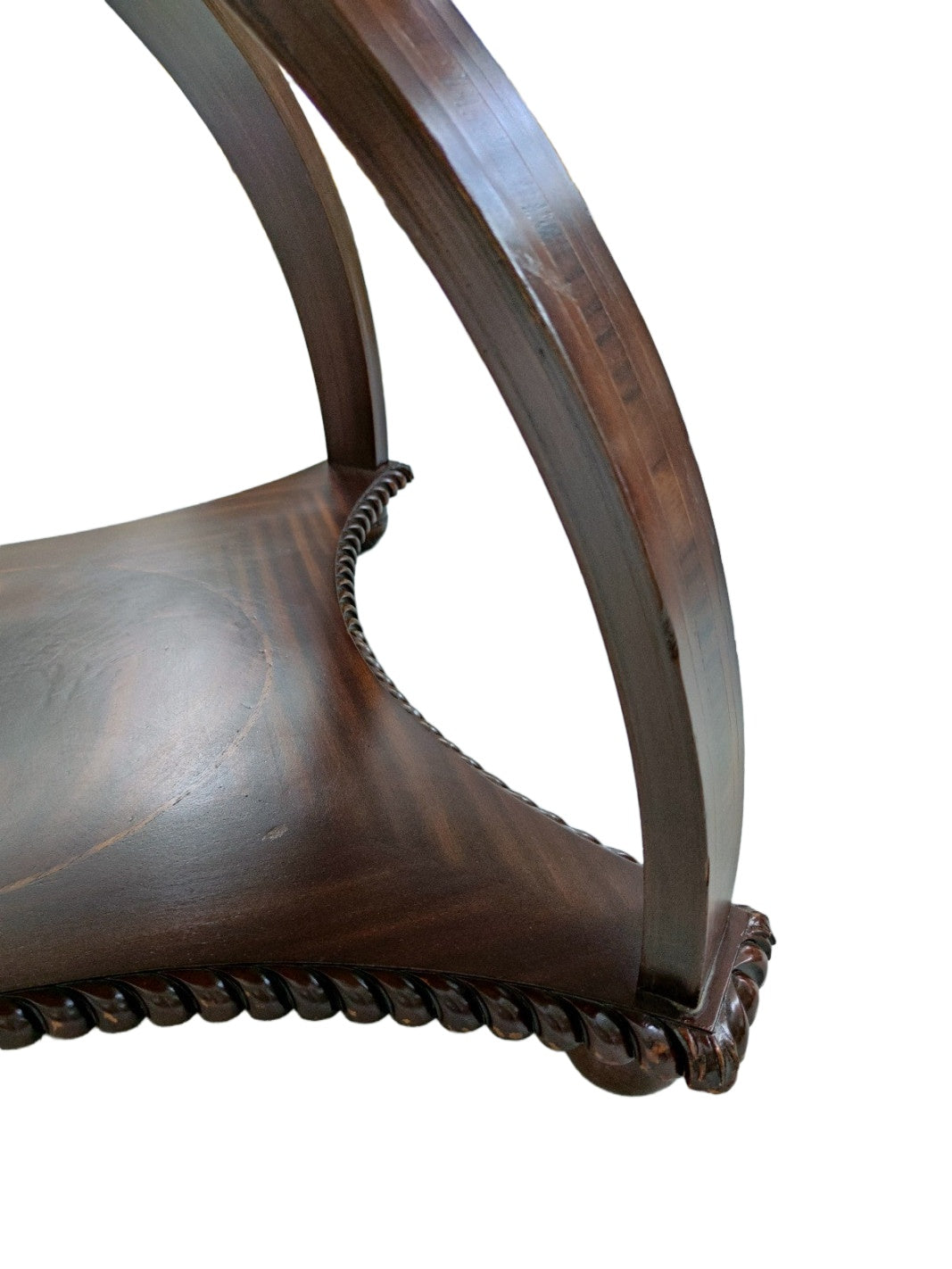 Original detail of the mahogany table showing the supports, shelf and surface wear
