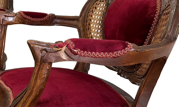 Original close-up showing frayed arm-pad upholstery and wear to the chair frame