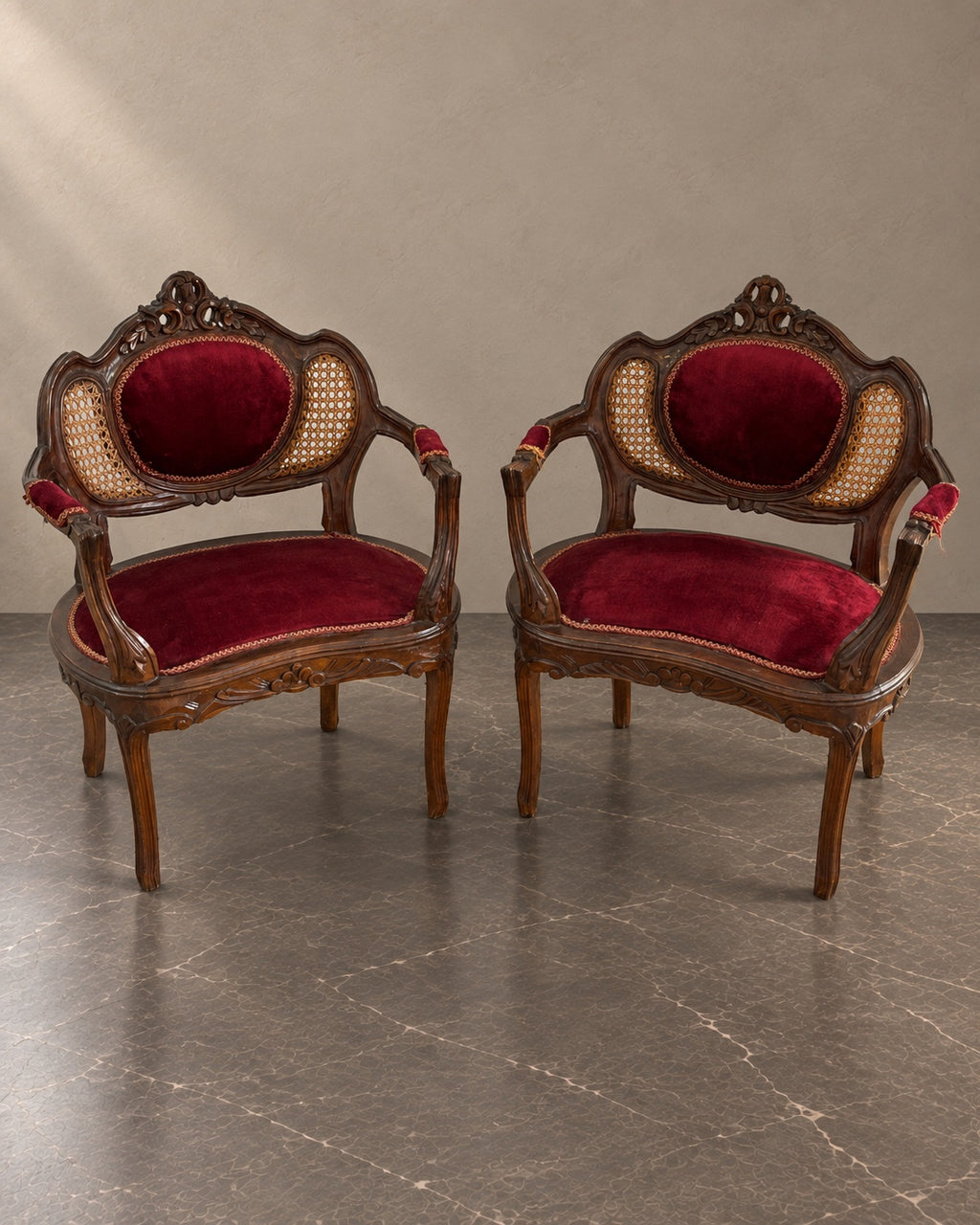 Pair of Napoleon III armchairs with burgundy upholstery and cane back panels