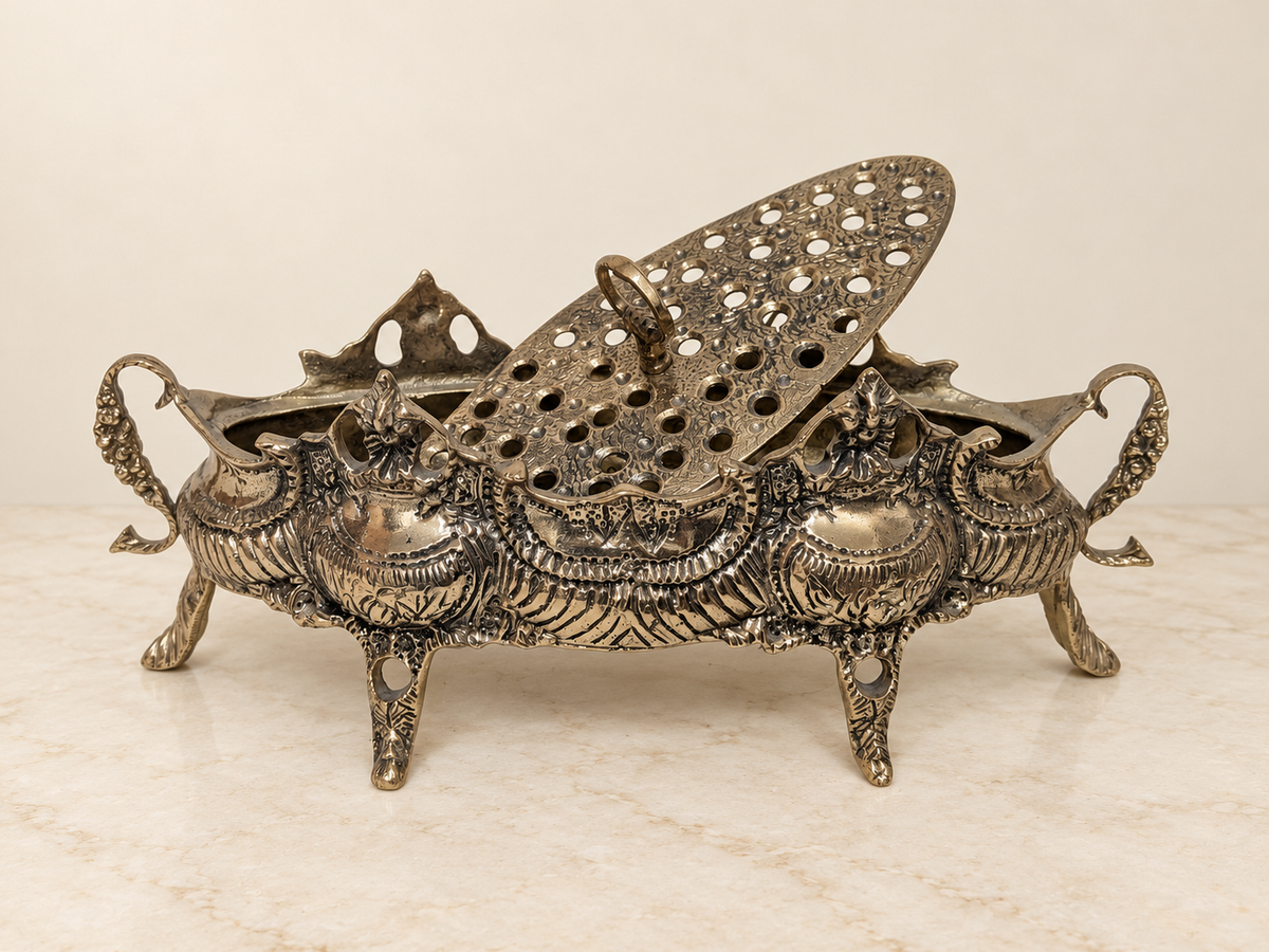 Ornate bronze flower bowl with pierced insert