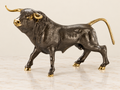 Textured bull sculpture with gold-tone accents