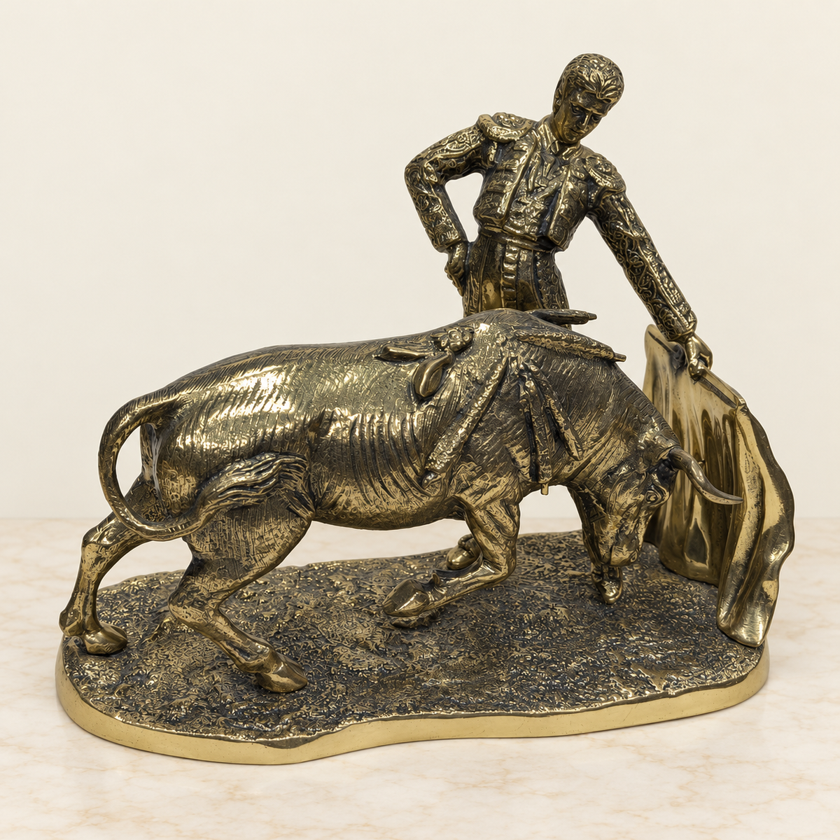 Bull and bullfighter sculpture with cape