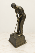 Standing golfer sculpture on a bronze pedestal