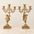 Pair of three-light winged cherub candelabra