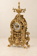 Openwork mantel clock with a tall urn finial