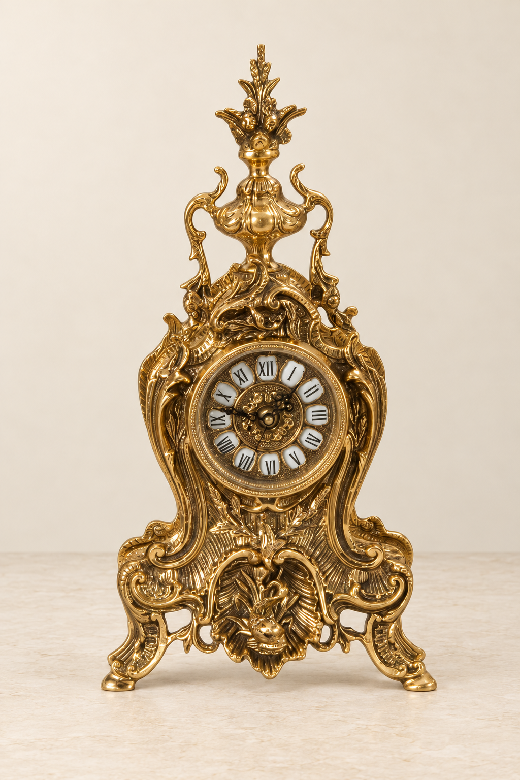 Scrollwork mantel clock with a leafy finial