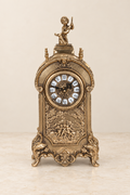 Cherub mantel clock with a figural relief panel