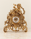 Mantel clock with reclining trumpet cherub