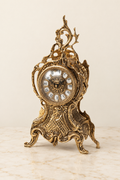 Mantel clock with pierced crest and mask relief