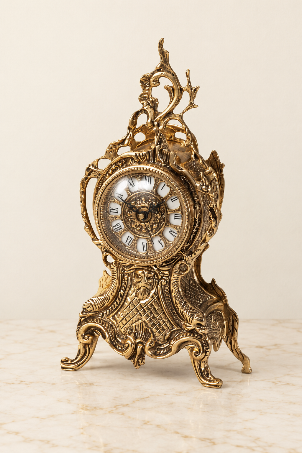 Mantel clock with pierced crest and mask relief