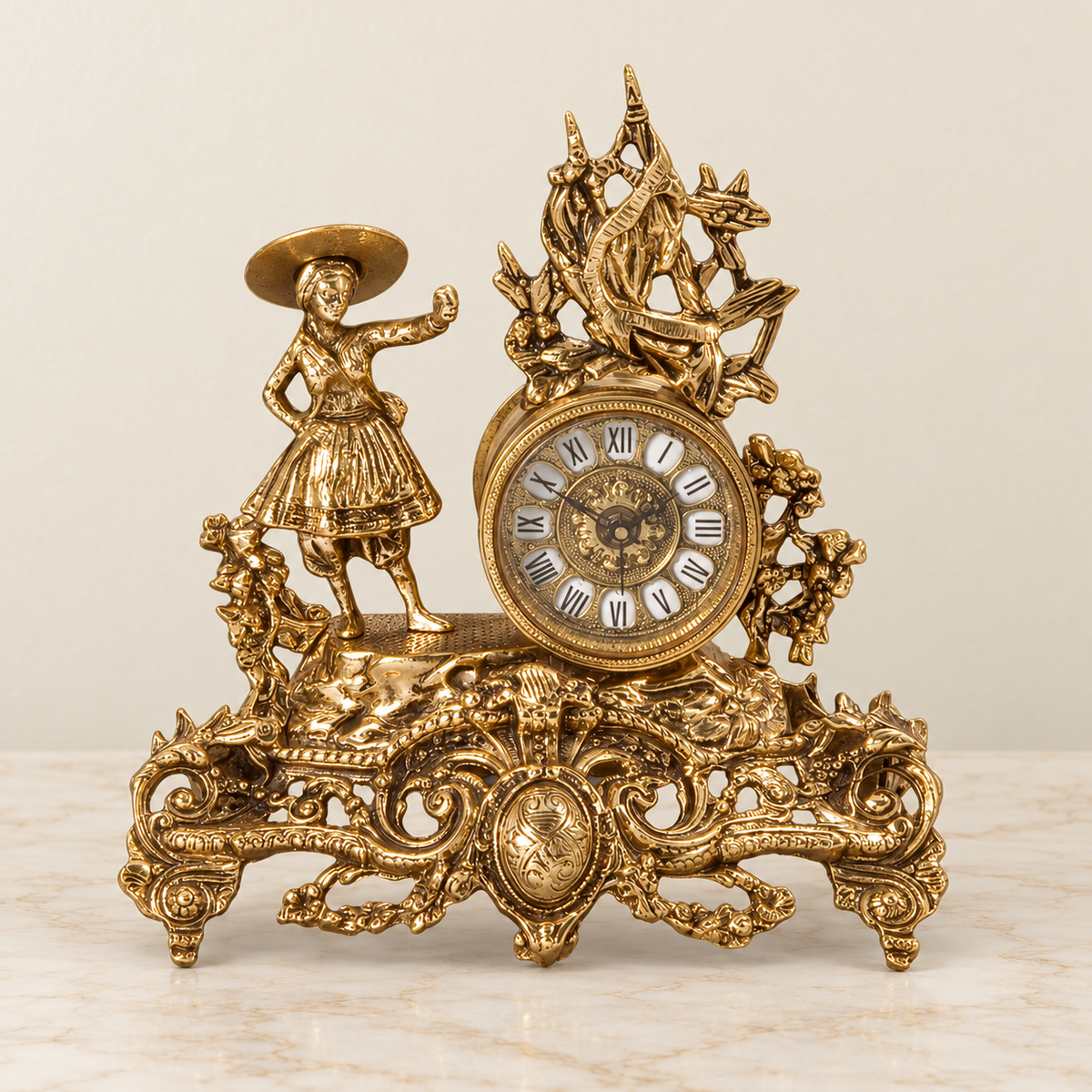 Figural mantel clock with scrolling base